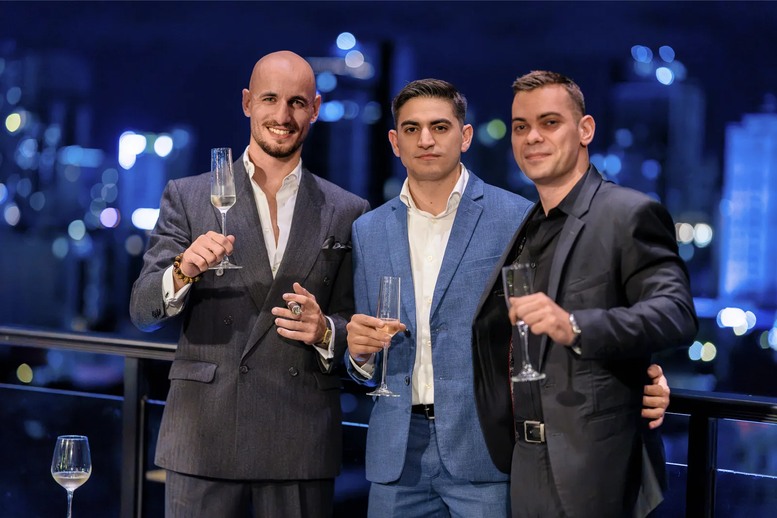 Red Raven founders with The Liquor & Cigar Boutique founder toasting on the T-One rooftop
