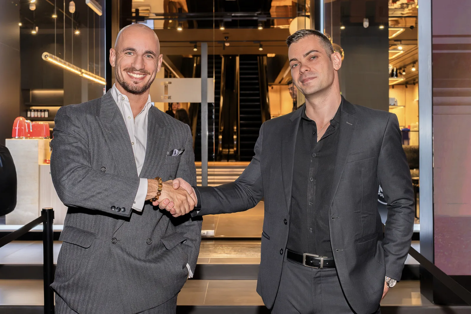 Red Raven and The Liquor & Cigar Boutique — partnership handshake at the venue entrance