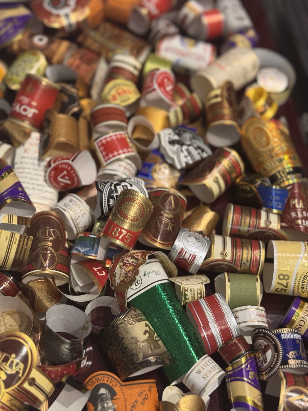 A collected pile of cigar bands from Red Raven evenings